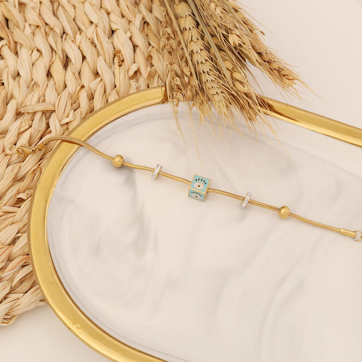 Bracelet porte-bonheur Olivenorma en époxy avec topaze bleue et trèfle mauvais œil