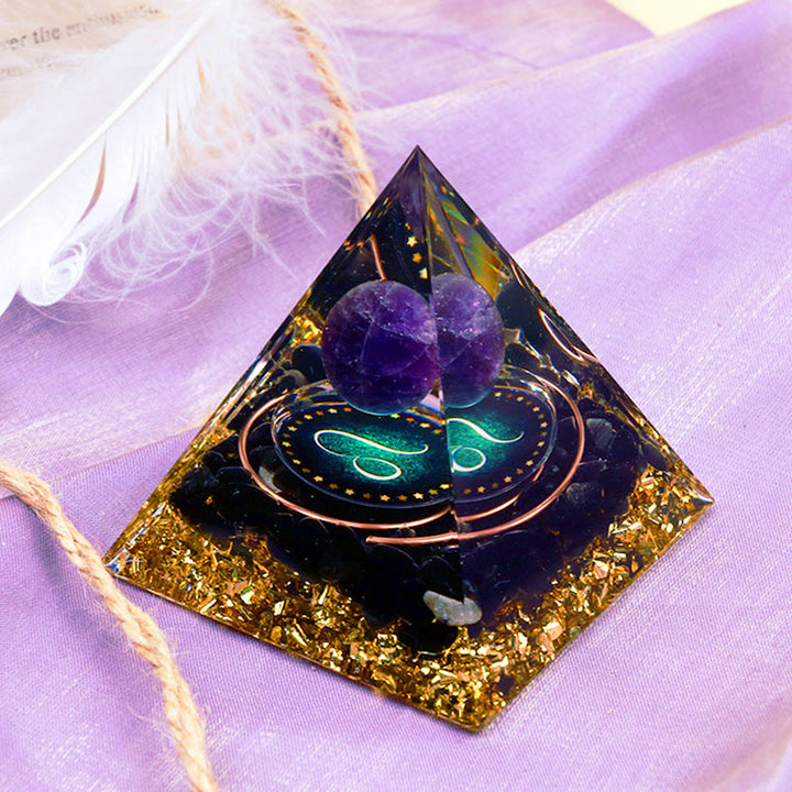 Sphère d'améthyste Olivenorma avec pyramide d'orgone du zodiaque Lion en obsidienne