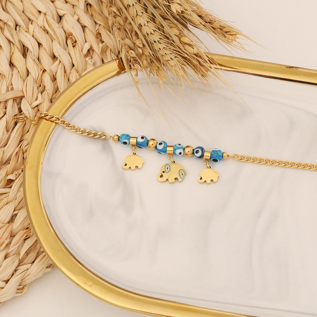Bracelet porte-bonheur Olivenorma en époxy avec topaze bleue et trèfle mauvais œil