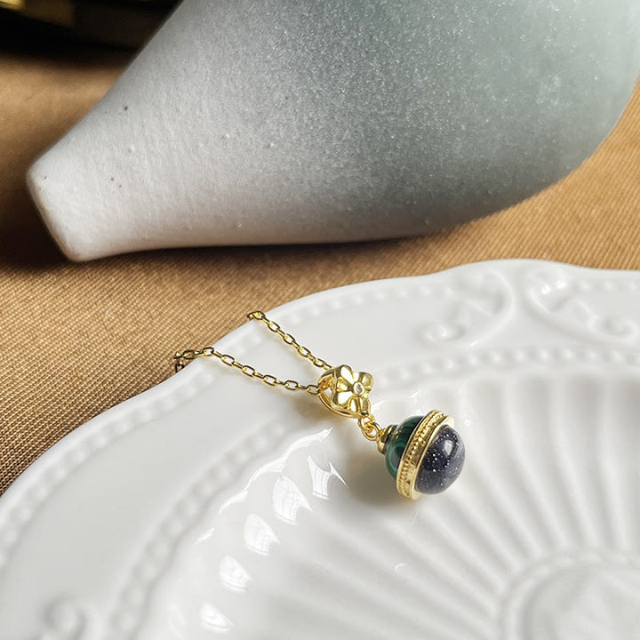 Collier pendentif en forme de sphère en grès bleu malachite « Stellar Corona » Olivenorma