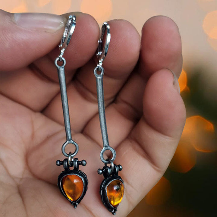 Boucles d'oreilles en pierre d'ambre en forme de goutte d'eau de la tribu Olivenorma 