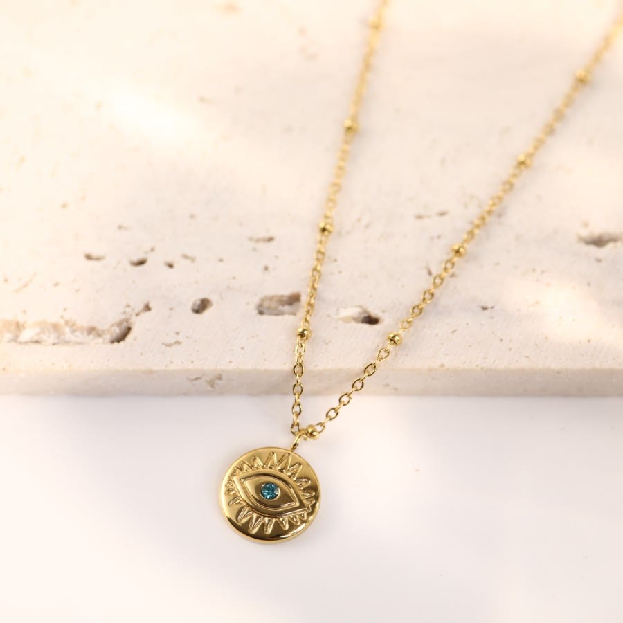 Collier Olivenorma en acier titane 316L avec topaze bleue et mauvais œil 