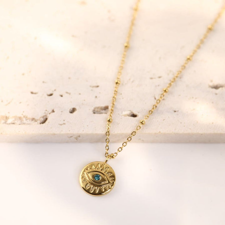 Collier Olivenorma en acier titane 316L avec topaze bleue et mauvais œil 