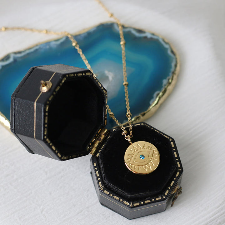 Collier Olivenorma en acier titane 316L avec topaze bleue et mauvais œil 